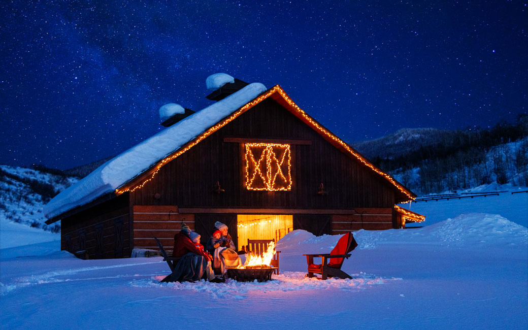 White lites line a snow-covered barn